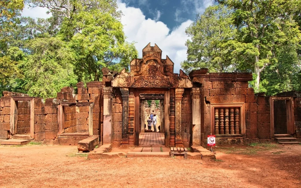 Ancient pink sandstone architecture and carved doorway at Banteay Srei Temple, Cambodia.