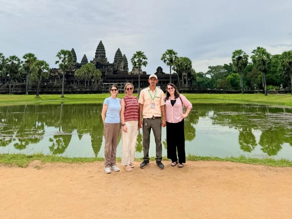 A photo of Phally with customer standing in front of Angkor Wat temple